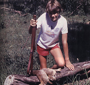 Young hunter with a .22 Brno Model 2 with a haul of rabbits.